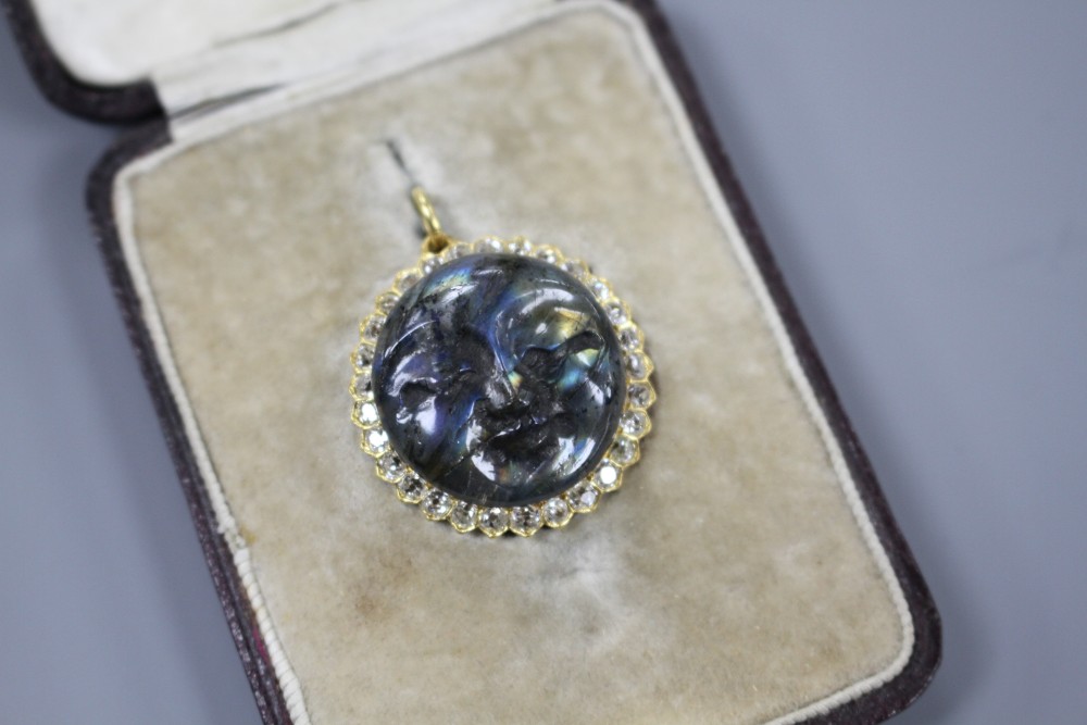 A 20th century yellow metal, diamond and carved labradorite? moon face pendant, 26mm, gross weight 7.2 grams.